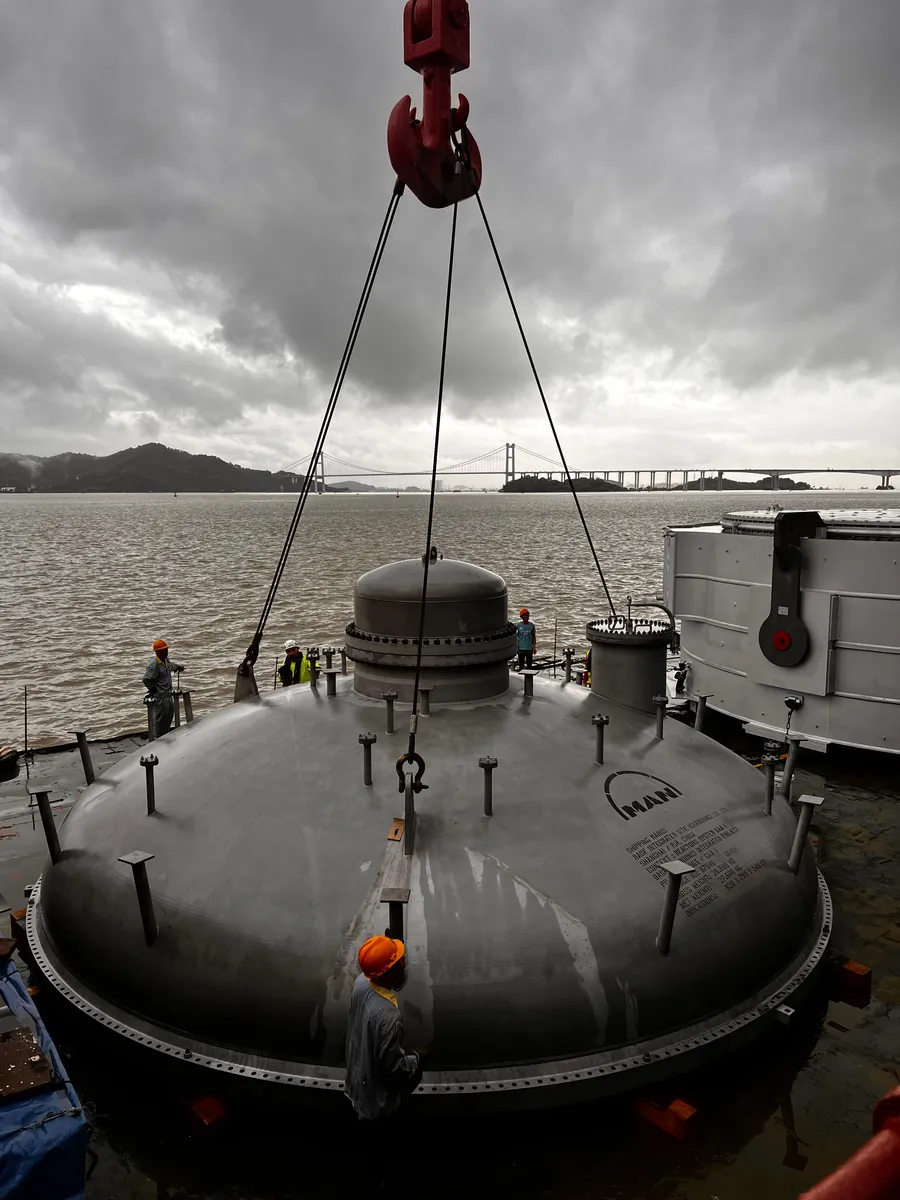 Lift team working around large industrial cargo on a vessel deck